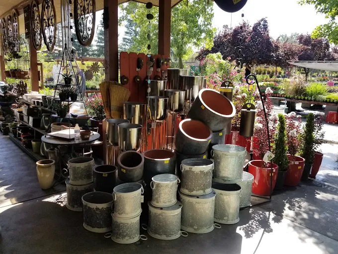 Stacks of glazed and stone pottery planters for sale